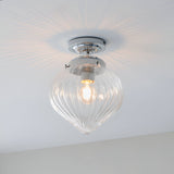 Endon Thornton flush bathroom ceiling light in chrome with a ribbed clear glass teardrop shade, shown illuminated against a white ceiling.