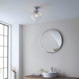 Endon Thornton flush bathroom ceiling light in chrome with a ribbed clear glass shade, mounted above a round chrome wall mirror and basin.