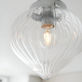 Close-up of the Endon Thornton flush bathroom ceiling light in chrome, with a ribbed clear glass teardrop shade and a lit E27 filament lamp.