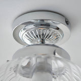 Close-up of Endon Thornton flush bathroom ceiling light showing polished chrome mount and ribbed glass diffuser fitted to a white ceiling.