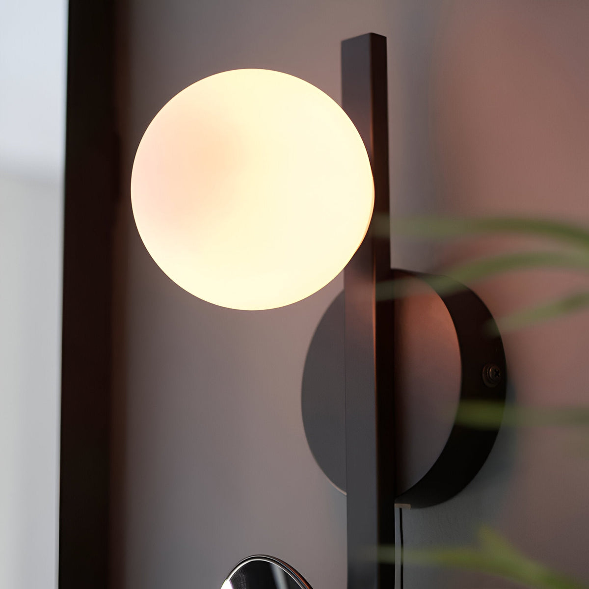 Endon Cliffshaw bathroom wall light in matt black, with a single opal glass sphere beside a round adjustable magnifying mirror on a slim frame.
