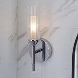 Endon Castbourne bathroom wall light in polished chrome with an upright ribbed glass torch shade and circular back plate, mounted on a marble wall.