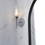 Endon Castbourne bathroom wall light in polished chrome with ribbed glass torch shade and frosted inner diffuser, mounted beside an arched mirror on marble.