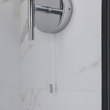 Endon Castbourne bathroom wall light in polished chrome with upward torch shade, circular back plate and pull cord switch, mounted on a marble wall.