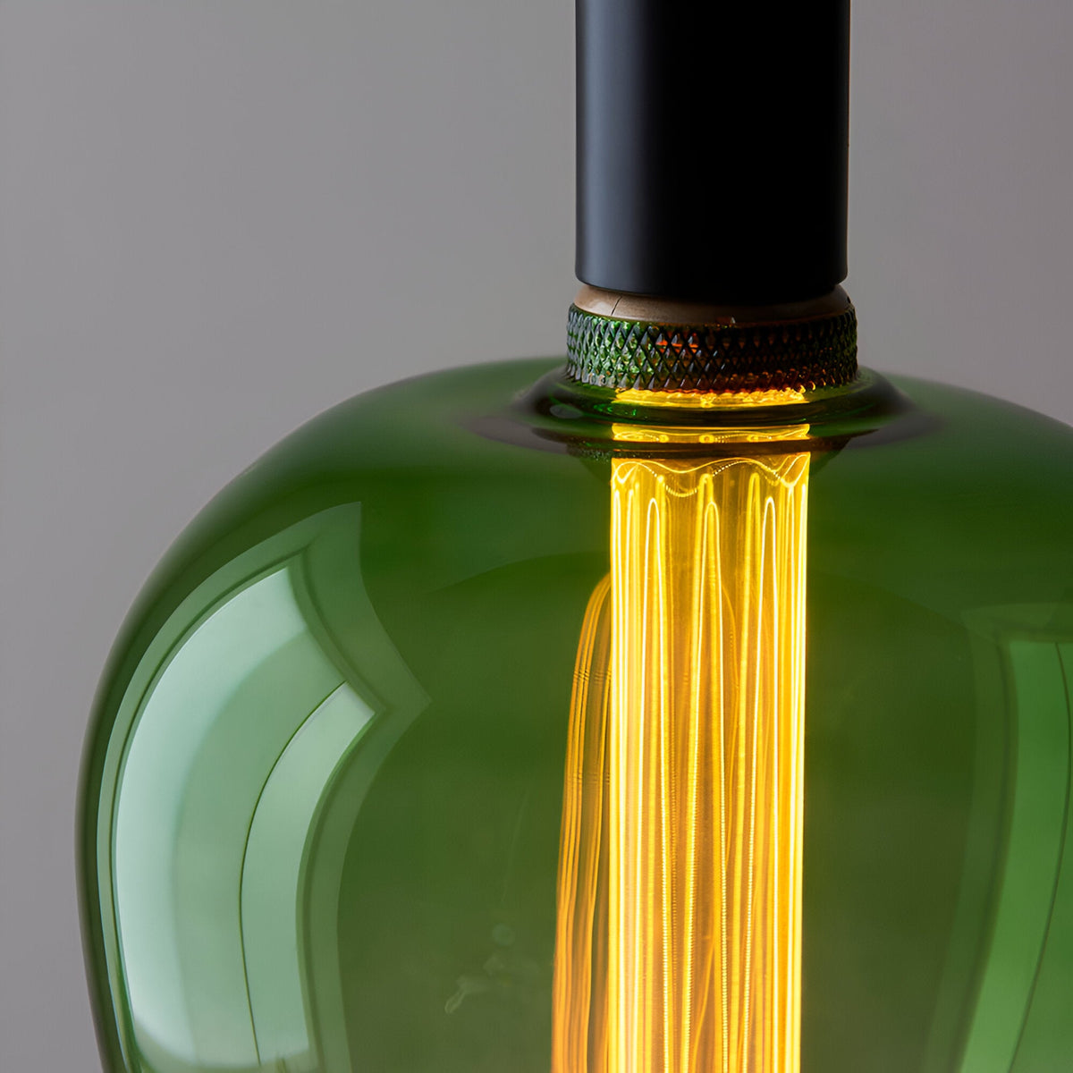 Close-up of Endon 2.8W E27 LED filament bulb with green ombre glass and warm white 1800K amber glow from the etched acrylic sleeve.