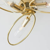 Close-up of Endon Hartley 3 light semi-flush ceiling light in brass, showing an oval arm with a clear glass cylinder shade and E14 lamp.