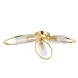 Endon Hartley 3 light semi-flush ceiling light in brass with three oval hoop arms and clear glass shades, shown on a plain white background.