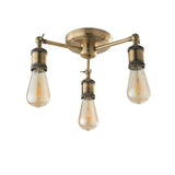 Endon Brackley 3 light semi-flush ceiling light in brass, with three angled arms holding exposed E27 filament bulbs, on a white background.