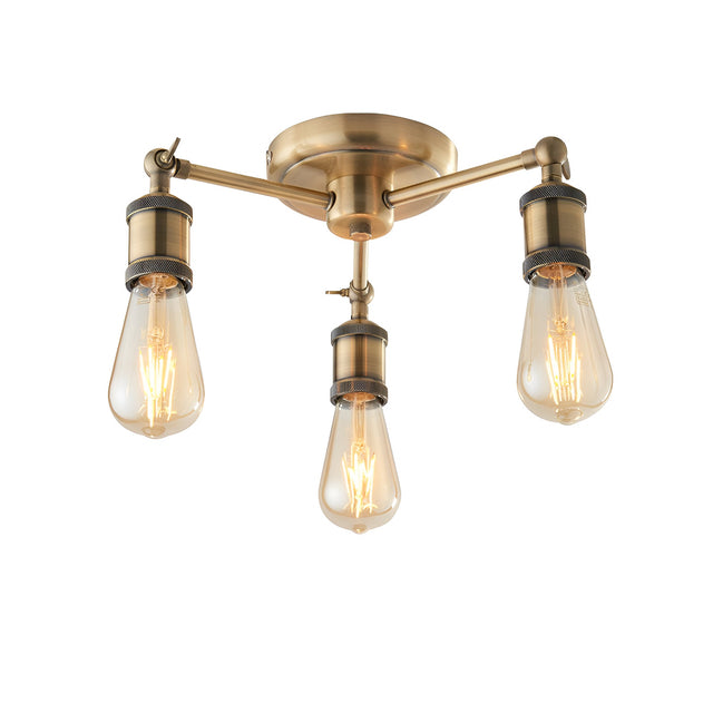 Endon Brackley 3 light semi-flush ceiling light in brass with three outward arms and exposed E27 filament bulbs, shown on a white background.