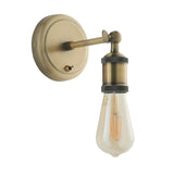 Brackley Wall Light in antique brass with round wall plate, adjustable arm and head, E27 bulb fitted, shown on a plain white background.