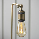 Close-up of the Brackley Table Lamp in brass, showing an adjustable knuckle joint, knurled lamp holder and exposed E27 bulb against a light background.