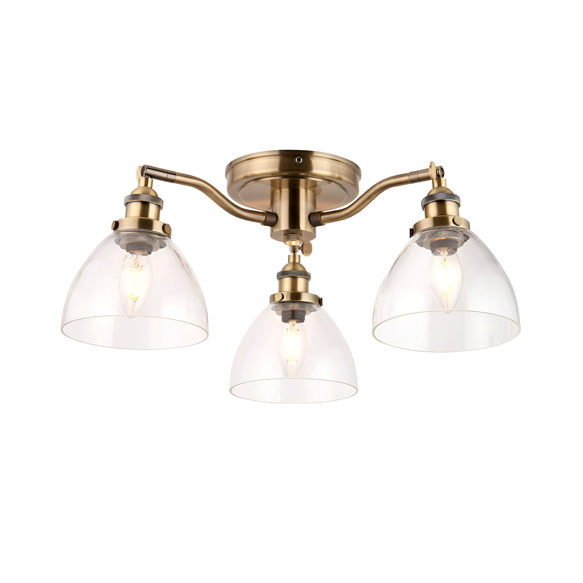 Wentworth 3-light semi-flush ceiling light in antique brass with clear glass dome shades on three arms, plain white background.