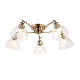 Endon Wentworth 5 light semi-flush ceiling light in antique brass with five clear glass dome shades on curved arms, shown on a white background.