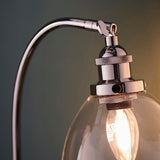 Close-up of Endon Wentworth table lamp showing nickel adjustable knuckle, knurled lamp holder, clear glass shade and visible filament E14 bulb.