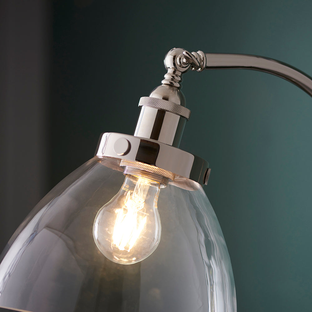 Close-up of Endon Wentworth Floor Lamp in nickel, showing knurled lamp holder, adjustable knuckle and clear glass shade with an exposed E27 filament bulb.