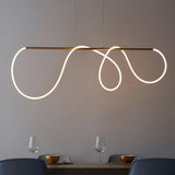 Aldley Linear Pendant in satin gold with a flexible LED tube curved into loops, suspended over a dining table with glassware and chairs below.