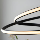 Close-up of the Endon Halden pendant light showing intertwined textured black loops with an illuminated white LED diffuser strip.