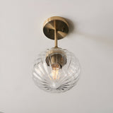 Endon Aldridge semi-flush ceiling light in antique brass with a ribbed clear glass globe shade and short brass stem, mounted on a pale ceiling.