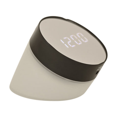 Round flip alarm clock with black plastic band and frosted clear plastic shade, tilted to display white LCD time digits, shown on a plain white background.