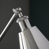 Close-up of the Endon Brackley floor lamp head and adjustable arm joint in bright nickel plate with knurled detailing against a dark background.