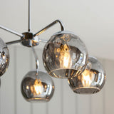 Draycott 5 Light Dimpled Glass Pendant in chrome, close-up of smokey mirrored glass globe shades on chrome arms with visible bulbs, plain white background.