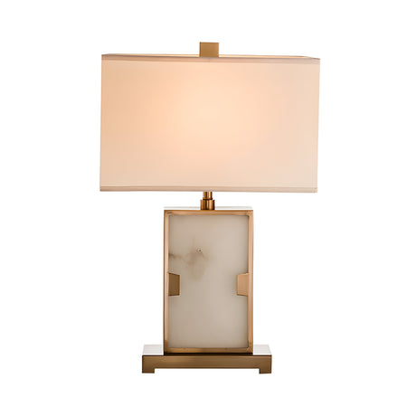 The Marcellin 1 Light Alabaster Table Lamp in Brass & Soft White features a modern design with a rectangular white shade, gold base, marble-like center, and emits a warm, soft light.