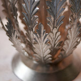 Close-up of the Endon Colette table lamp base showing layered silver metal leaves rising from a round pedestal foot.