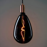 4W E27 LED Filament Wisp Bulb in smoke glass with copper-toned fitting, showing a wispy warm white filament, on a grey background.