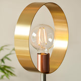 Brenmere Floor Lamp with open brass hoop frame, brushed copper bulb holder, exposed E27 filament globe bulb and nickel stem, plain light background.