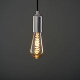 Endon 4W E27 LED filament twist bulb with amber tinted teardrop glass and spiral filament, suspended from a chrome lamp holder on a black flex.