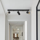 Calder 3 Light Spotlight Plate in matt black metal, three angled GU10 heads on a bar, fitted to a hallway ceiling.