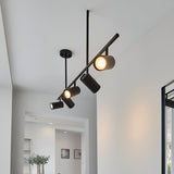 Calder 5 Light Spotlight Bar in matt black, angled metal bar with five adjustable GU10 heads, shown ceiling-mounted in a hallway setting.