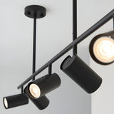 Calder 5 Light Spotlight Bar in matt black metal, close-up of adjustable cylindrical heads with GU10 bulbs on a slim ceiling-mounted bar.