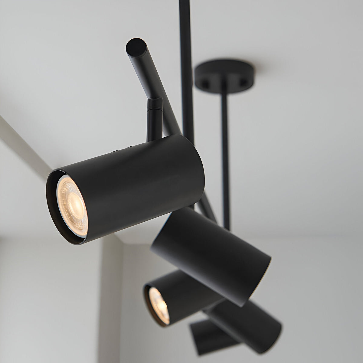 Calder 5 Light Spotlight Bar in matt black, ceiling-mounted with adjustable cylindrical heads, GU10 bulbs, shown against a plain white ceiling.