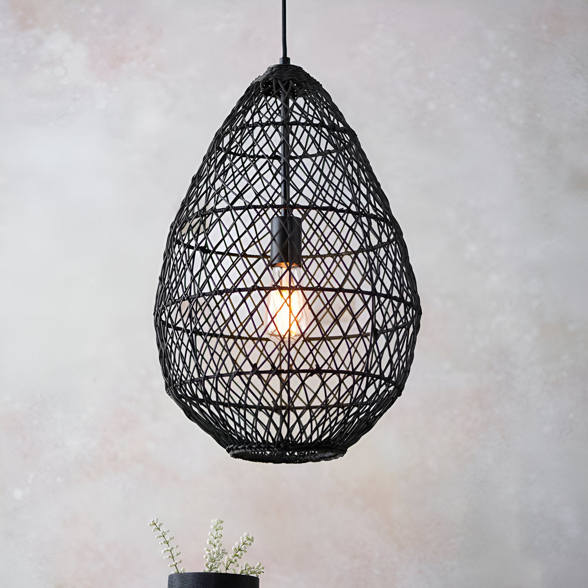 Endon Chartdale pendant light with a teardrop-shaped open-weave black rattan shade and single E27 Edison bulb, hung against a soft neutral background.