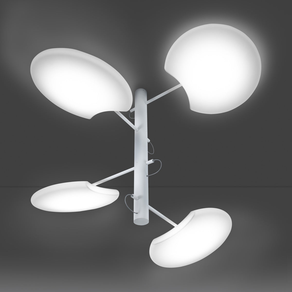 SuperMoon LED semi-flush ceiling light in white, with a slim central stem and four staggered arms holding crescent-cut, moon-like discs, set against a dark grey background.