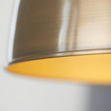 Close-up of Endon Bramdale medium pendant shade rim in antique brass, showing the rolled edge and warm yellow interior.