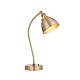 Endon Bramdale industrial table lamp in antique brass with curved stem, adjustable domed shade, and round base on a plain white background.