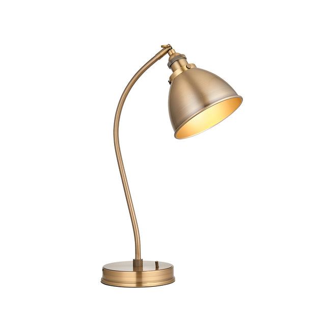 Endon Bramdale industrial table lamp in antique brass with curved stem, adjustable domed shade, and round base on a plain white background.
