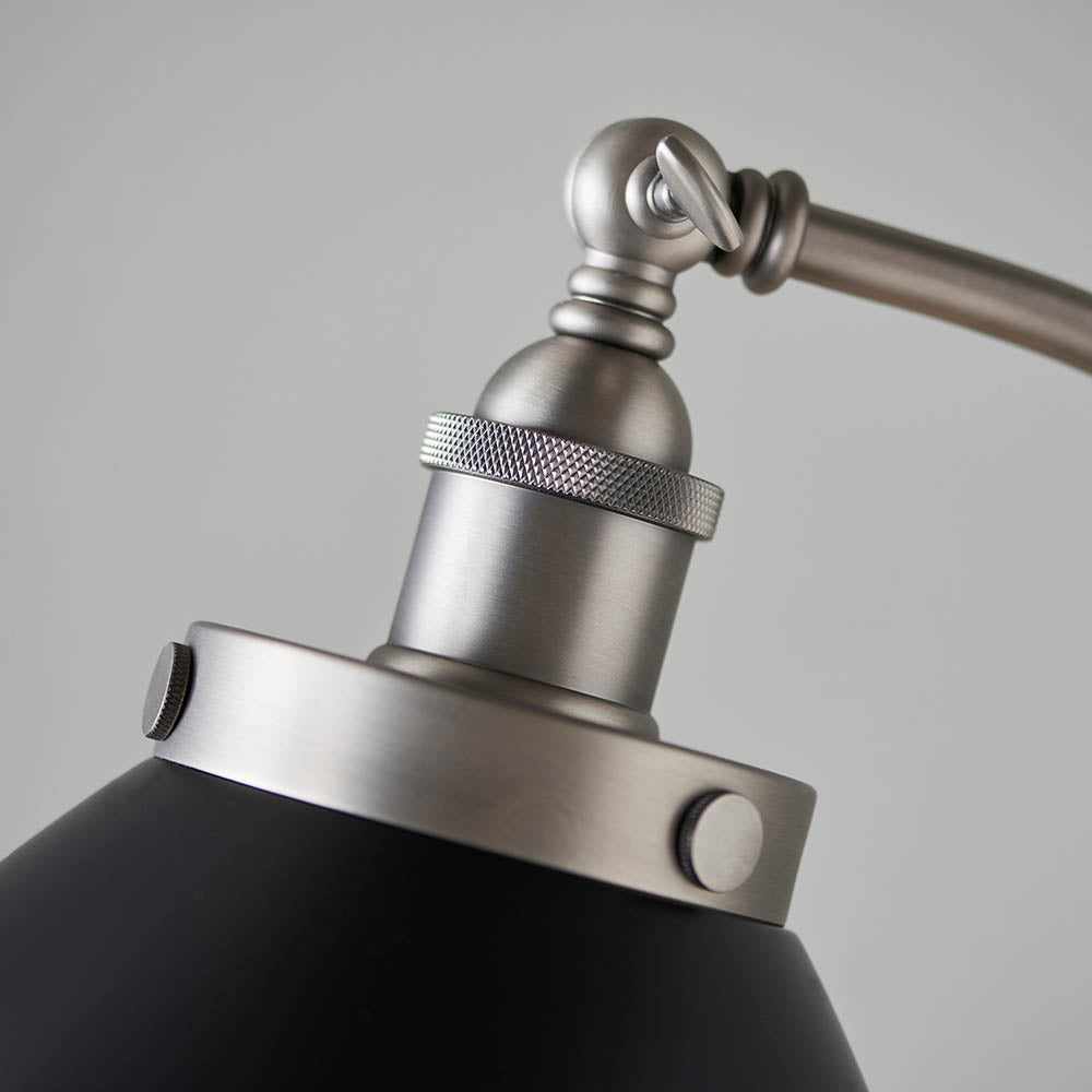 Close-up of the Bramdale Floor Lamp's adjustable head, showing the knurled silver joint, E27 bulb holder, and black metal shade against a plain background.