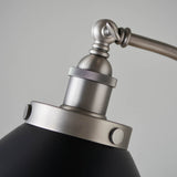 Close-up of the Bramdale Floor Lamp's adjustable head, showing the knurled silver joint, E27 bulb holder, and black metal shade against a plain background.