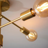 Close-up of Endon Marlowe 5 Light Semi-Flush Ceiling Light in satin brass, showing angled arms with cylindrical E27 lampholders and lit globe bulbs.