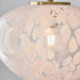 Close-up of the Calloway Pendant in Brass & White, showing the mottled white confetti glass shade with satin brass fitting and illuminated E27 bulb inside.