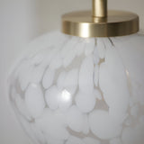 Close-up of the Endon Calloway table lamp showing the satin brass cap and white confetti blown glass shade.