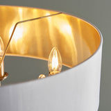 Close-up of Endon Brenley V1 6 Light Pendant showing a white fabric shade with gold-lined interior and lit E14 candle bulbs on chrome arms.