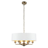 Endon Brenley V1 six-light pendant with a wide white drum shade, gold-lined interior and antique brass arms on a chain, shown on a white background.