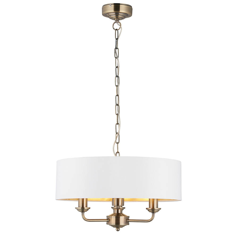 Endon Brenley 3 light pendant in antique brass with a white drum shade and gold-lined interior, suspended on a chain, shown on a white background.
