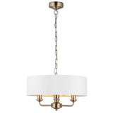 Endon Brenley 3 light pendant in antique brass with a white drum shade and gold-lined interior, suspended on a chain, shown on a white background.