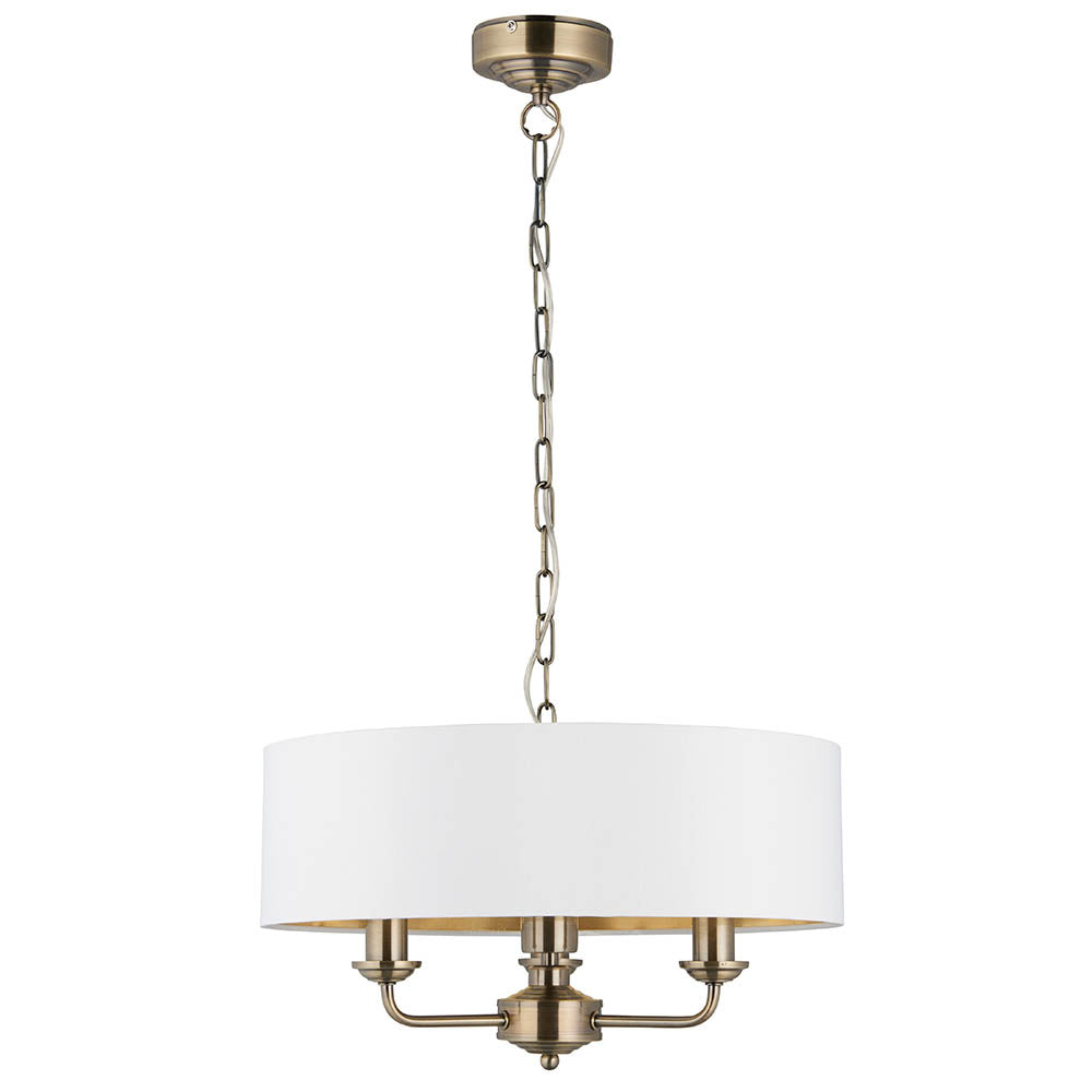 Endon Brenley 3 Light Pendant in antique brass with a white drum shade and gold-lined interior, suspended on a brass chain against a white background.