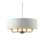 Endon Brenley pendant light with antique brass multi-arm frame and white drum shade with gold-lined interior, suspended from a chain on a white background.